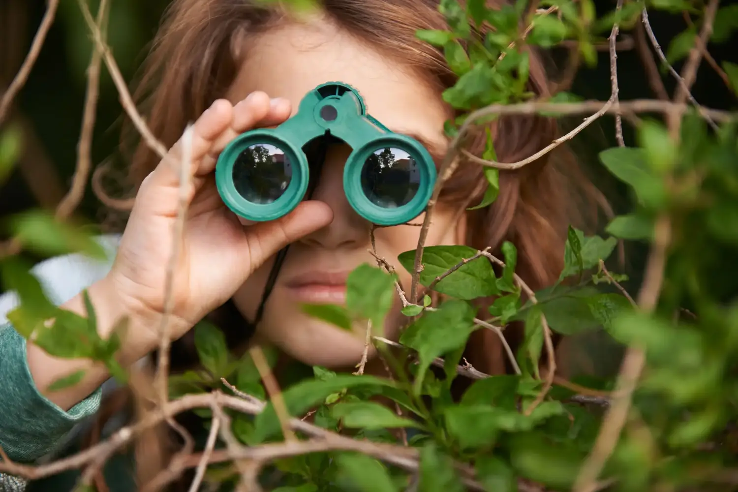 a girl looking through binoculars